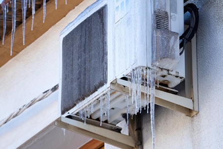A damaged, freezing HVAC unit is shown to highlight that Dependable Service can help even in the coldest weather.