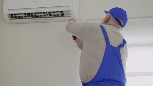 A technician repairing the AC unit